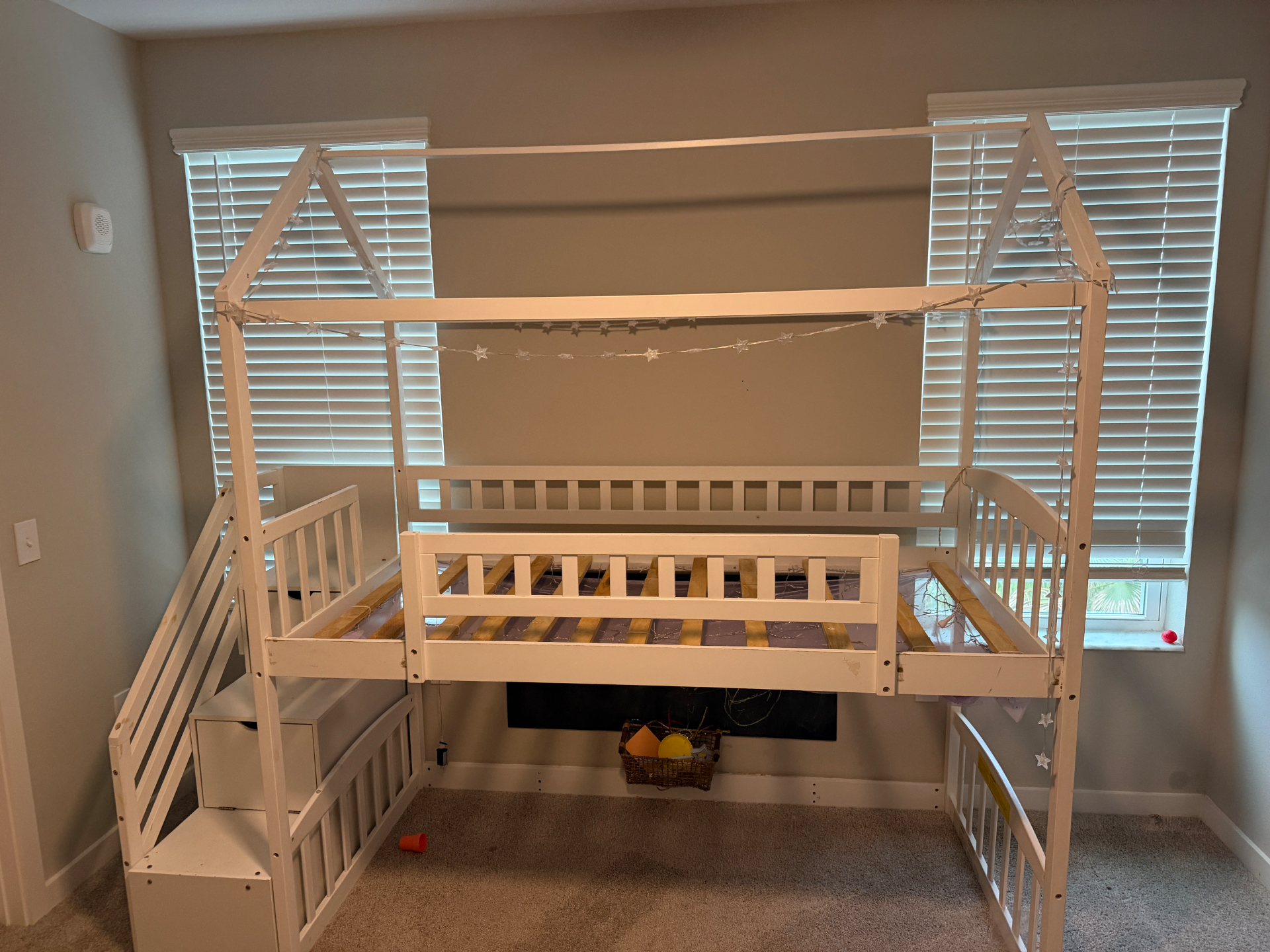 Kids bedroom with a wooden loft bed frame before removal